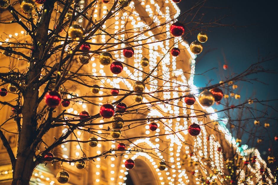 Close-up of a decorated tree with baubles and lights during the festive Christmas season.