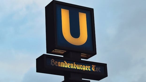 pexels-photo-776132-776132 U-Bahn sign at Brandenburger Tor station in Berlin, Germany against a cloudy sky.